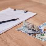 Improving Accessibility: Making University LMS Platforms Inclusive for All document, pen and dollar bills on table, close up