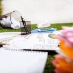 heap of business objects and office supplies laying on green grass carpet at office, business